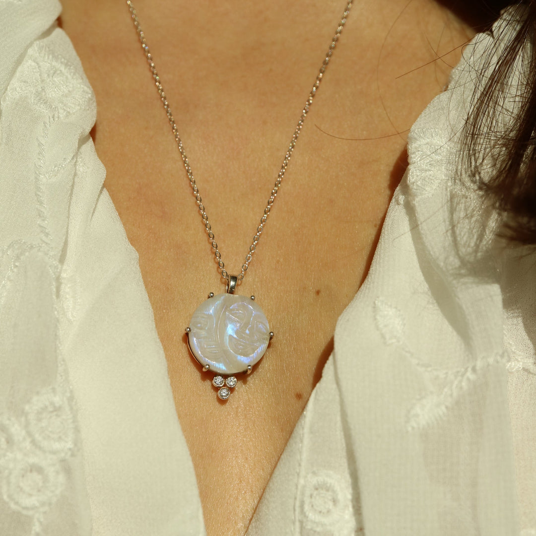 Half moon and crescent moon phases pendant necklace featuring a carved rainbow moonstone with a smiling face, set in sterling silver with cubic zirconia accents